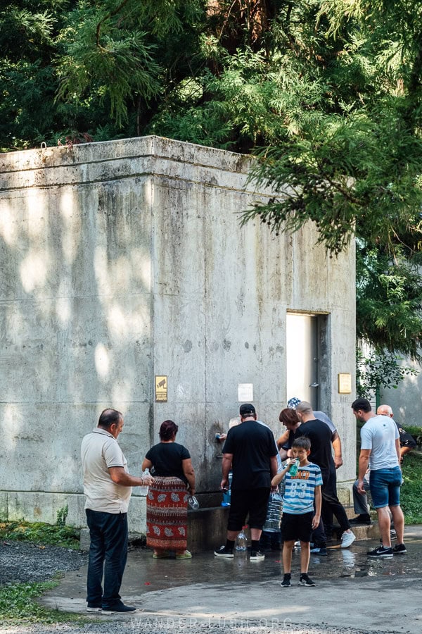 People queue in front of a Nabeghlavi mineral water spring waiting to fill up plastic bottles.