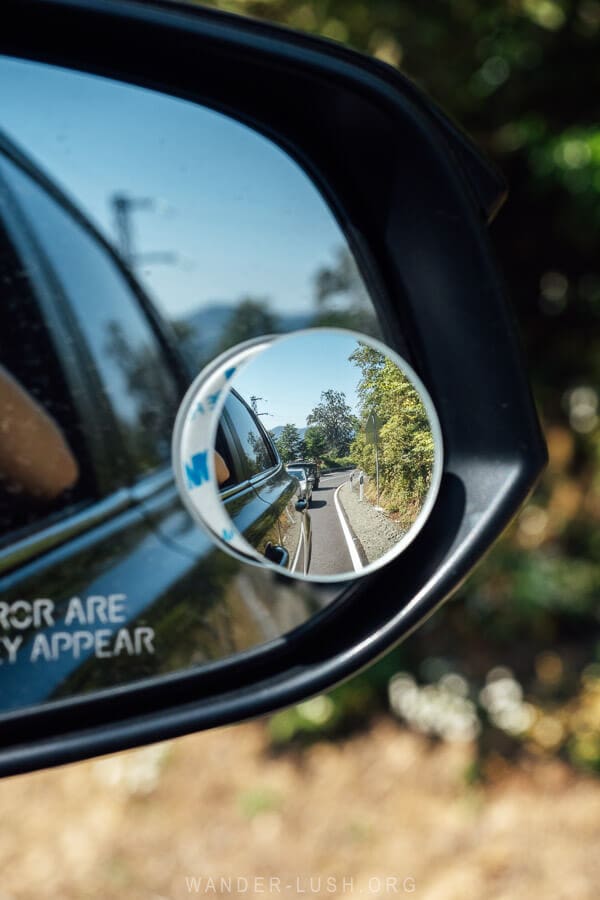 Looking in a rearview mirror at traffic on the road to Bakhmaro.