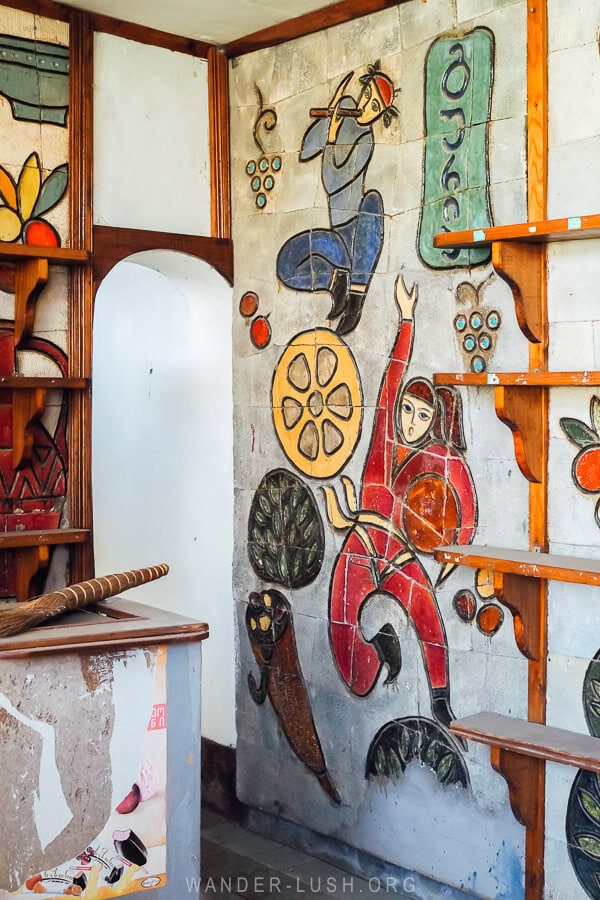 A beautiful Soviet mosaic depicting Gurian dancers and flute players inside an abandoned shop.