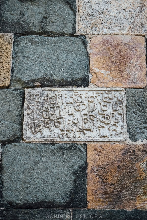 A stone inscription on the facade of Shemokmedi Monastery in Guria, Georgia.