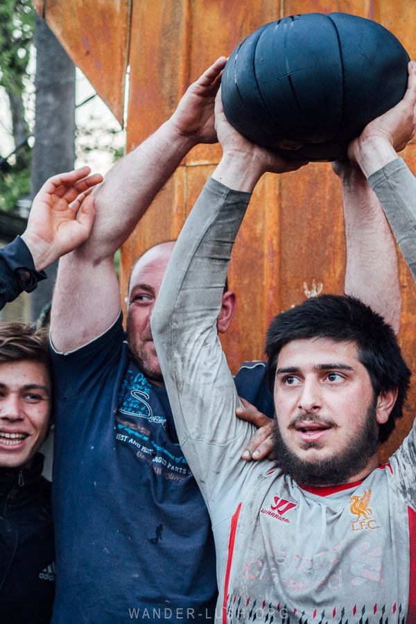 A man holds a ball above his head during the Lelo Burti festival in Guria, Georgia.