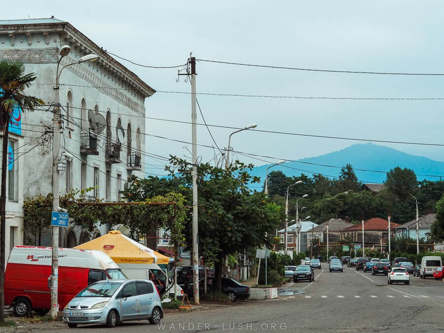 A quiet street in Ozurgeti, with a mountain looming in the distance.