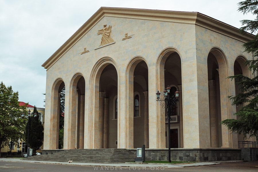 Ozurgeti Dramatic Theatre, an imposing Soviet-style building with high narrow arches and a peaked roof.