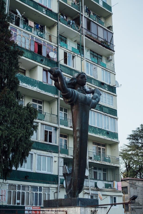 A statue and Soviet apartment block in Ozurgeti, Georgia.