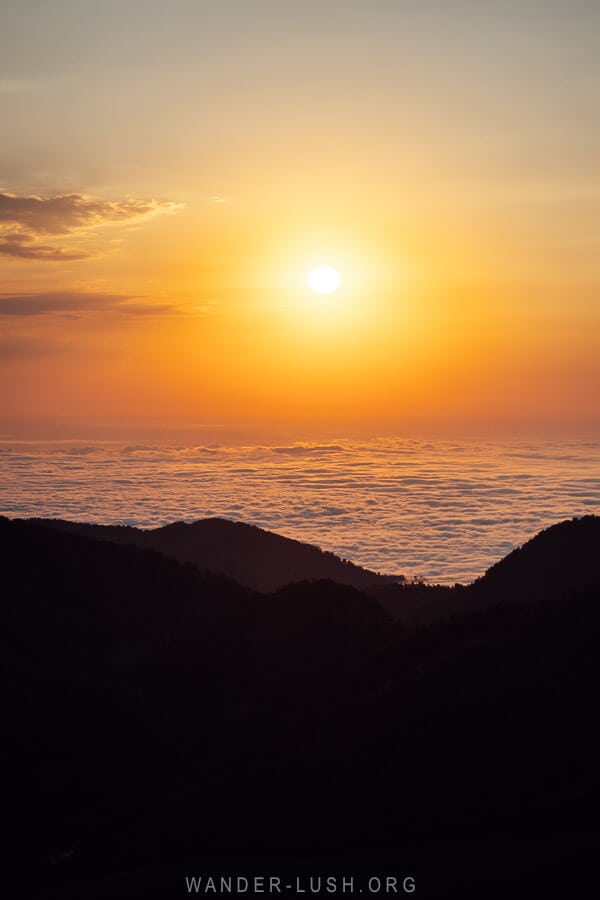 A golden sunset over a sea of clouds in Bakhmaro, Georgia.