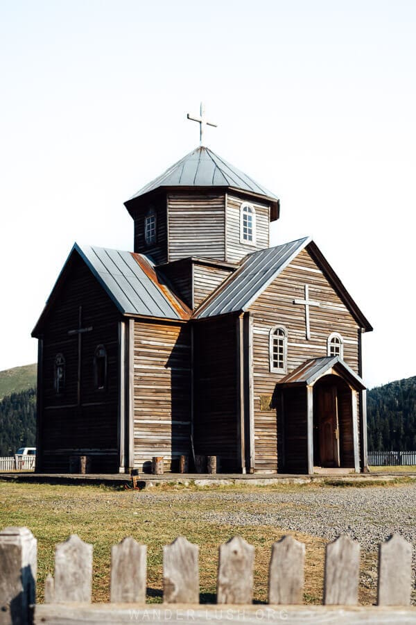 A wooden church behind a fence in Bakhmaro, Georgia.