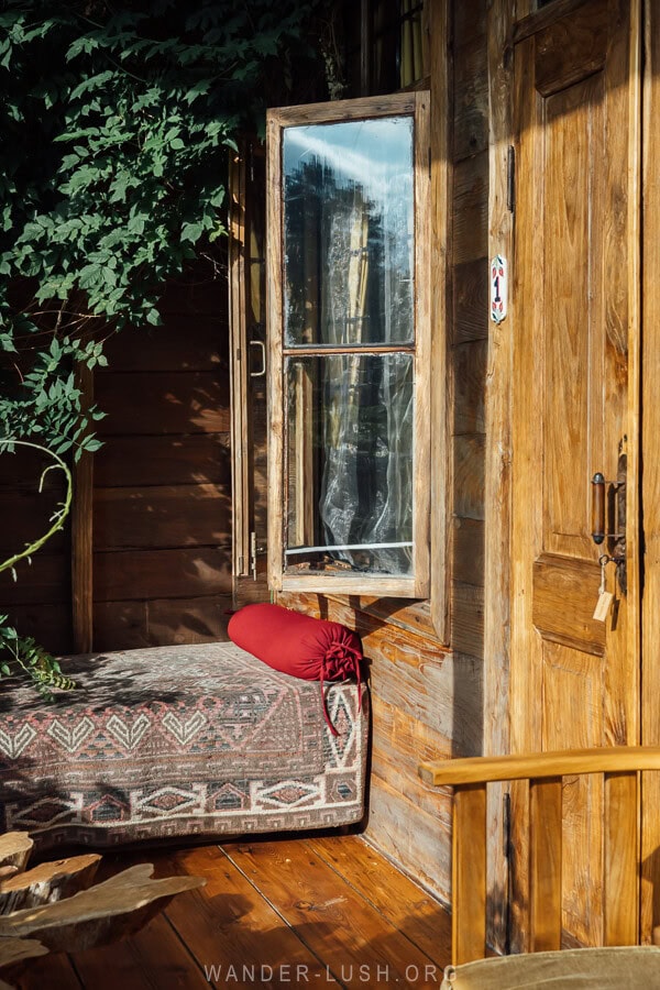 A sunlit balcony crafted from wood at Menabde in Guria.