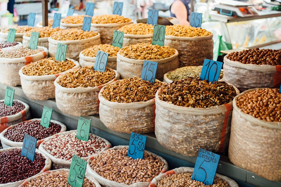 Bags of nuts stacked at a market stall.