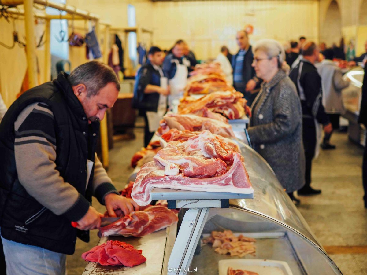 A butcher carving meat at his shop inside the Dezerter Bazaar in Tbilisi.