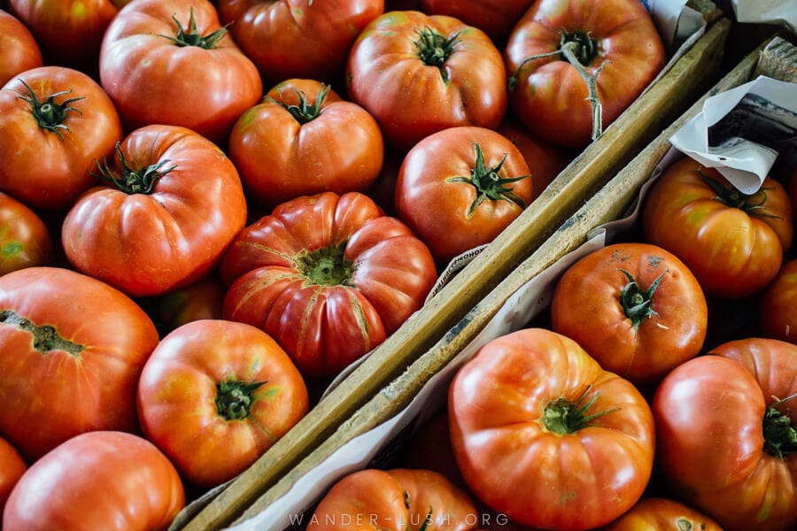 Fresh tomatoes in a cardboard box.