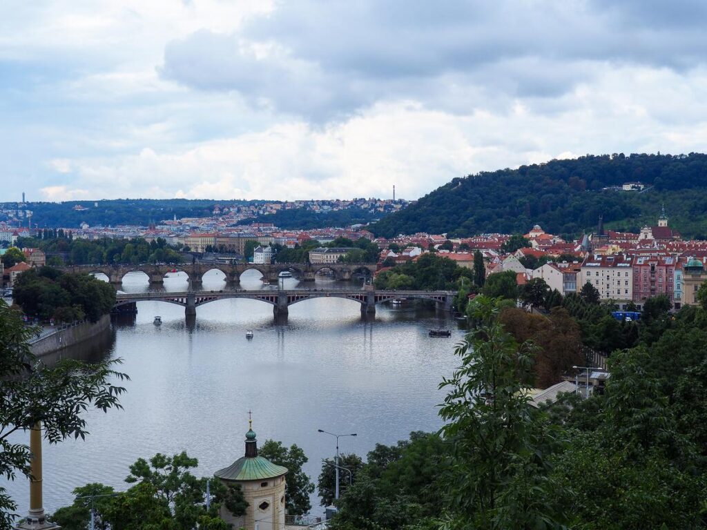 Alt-text: Panoramic view of historic bridges over the Vltava River in Prague, Czech Republic