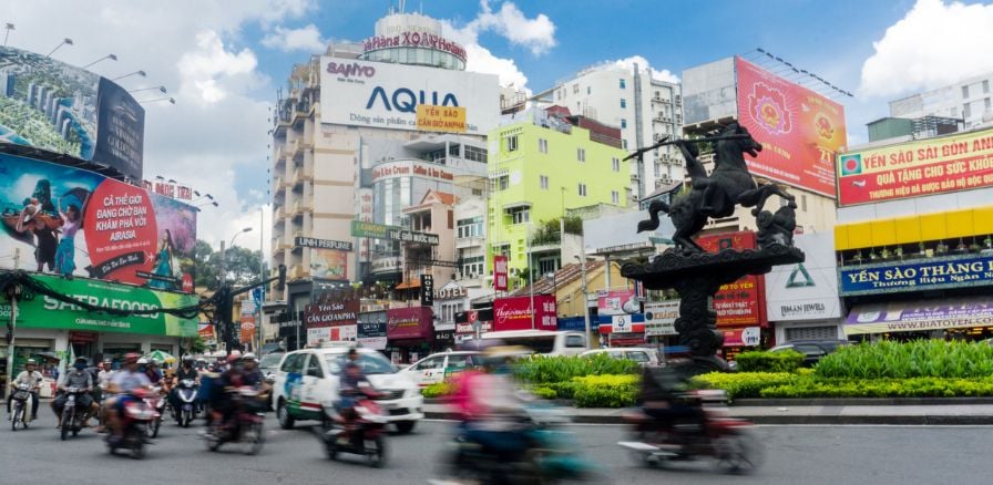 Ho Chi Minh City, Vietnam, city street with blurred traffic passing by 