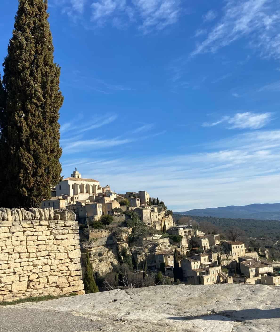 View of Gordes, France from the road with a tree in the foreground