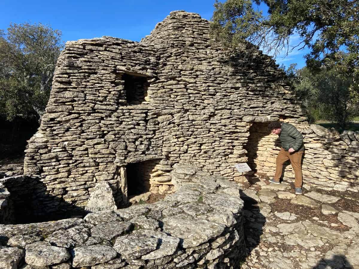 Colin going into one of the structures at Le Village des Bories, Gordes, France