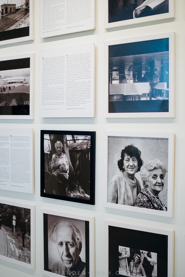 A wall of photographs and framed letters at a museum in Korca.