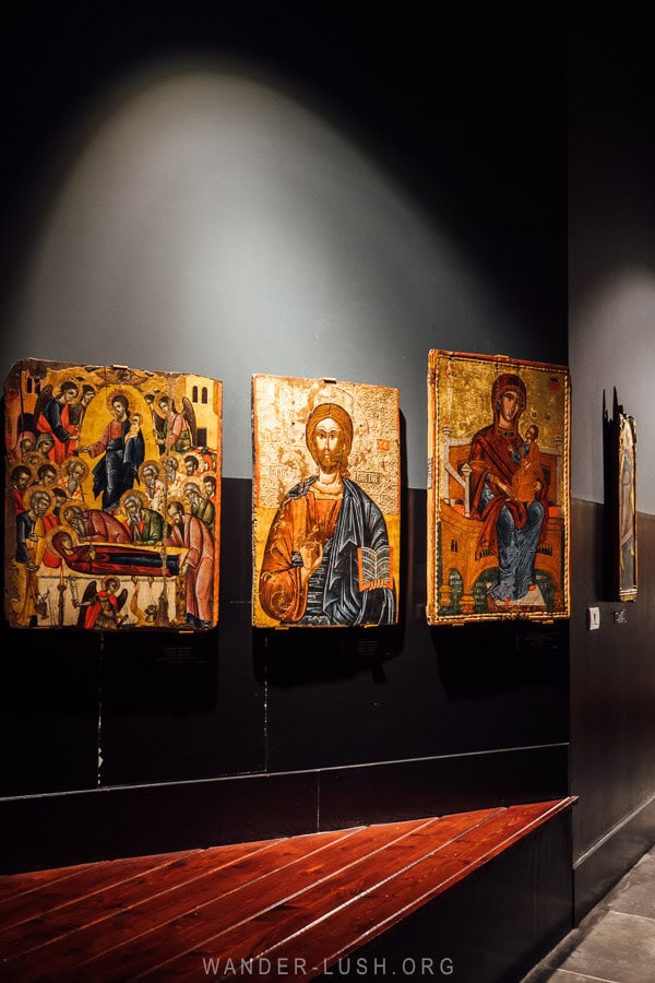 Icons lit by dramatic gallery spotlights at the National Museum of Medieval Art in Korca, Albania.