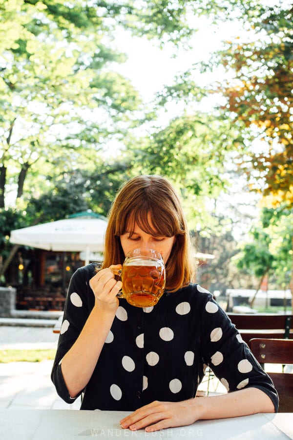 Emily drinking a mug of beer at the Birra Korca brewery.