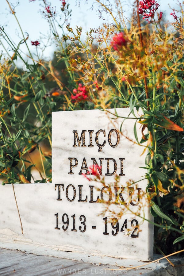 A white headstone bearing the name of a fallen solider at the Martyrs Cemetery in Korce, Albania.