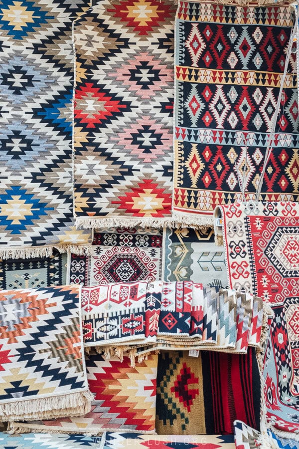 Colourful carpets hanging inside the Korca Old Bazaar.