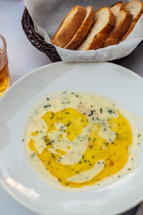 A bowl of traditional Permet soup with chicken and cream.