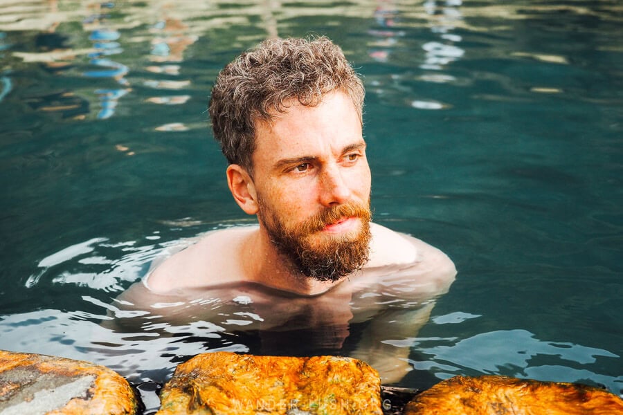 A man swimming in a thermal pool in Albania.