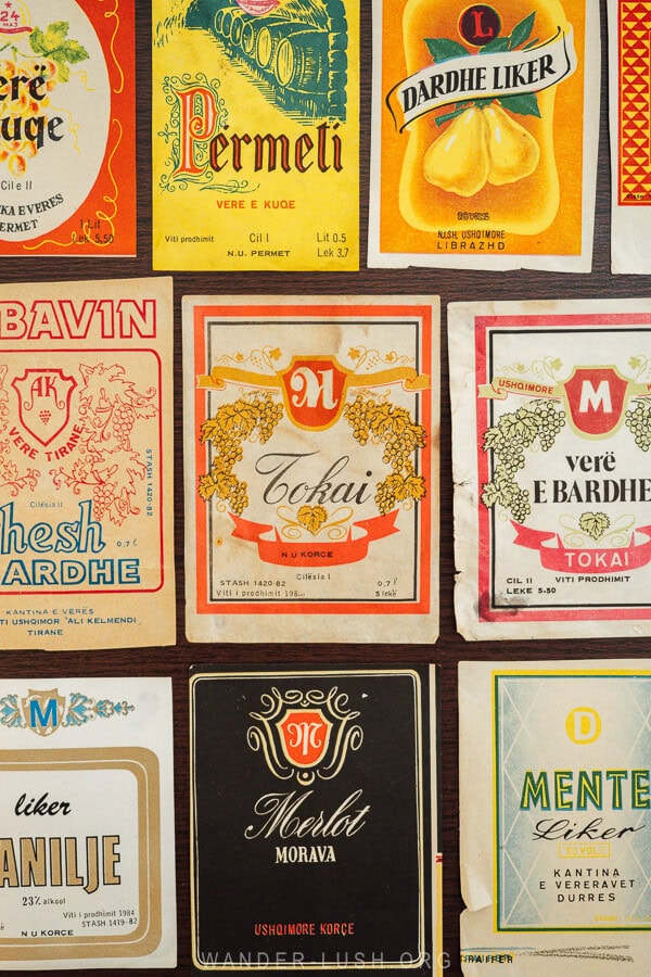 Old wine and spirit labels displayed at a souvenir shop in Permet, Albania.