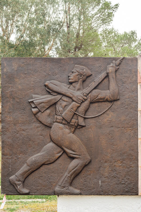 A bronze panel depicting a soldier at an Albanian war memorial in Permet.