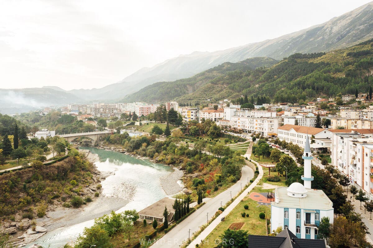 View of the city of Permet in Albania, with the Vjosa River, colourful architecture and the Permet Mosque.