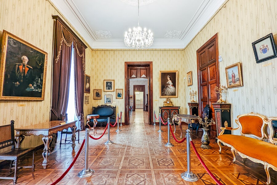 A luxurious room filled with paintings and furniture at the Dadiani Palace Museum in Zugdidi.