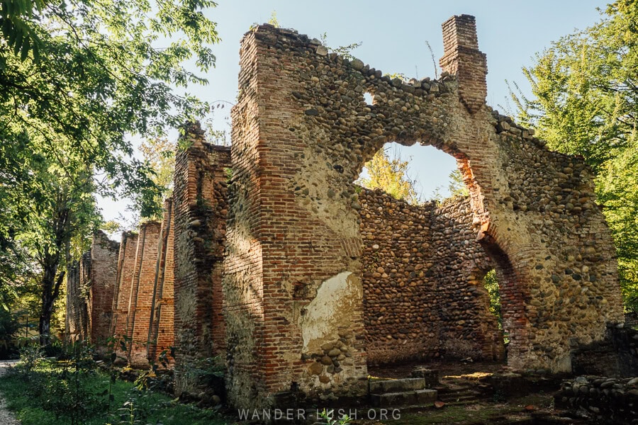 The ruins of a brick orangery inside Zugdidi Botanical Garden.