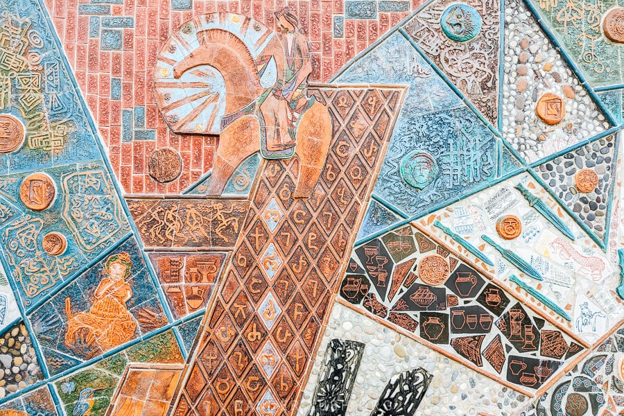 A wall decorated with mosaics and clay pottery at Orkol Studio in Zugidid.