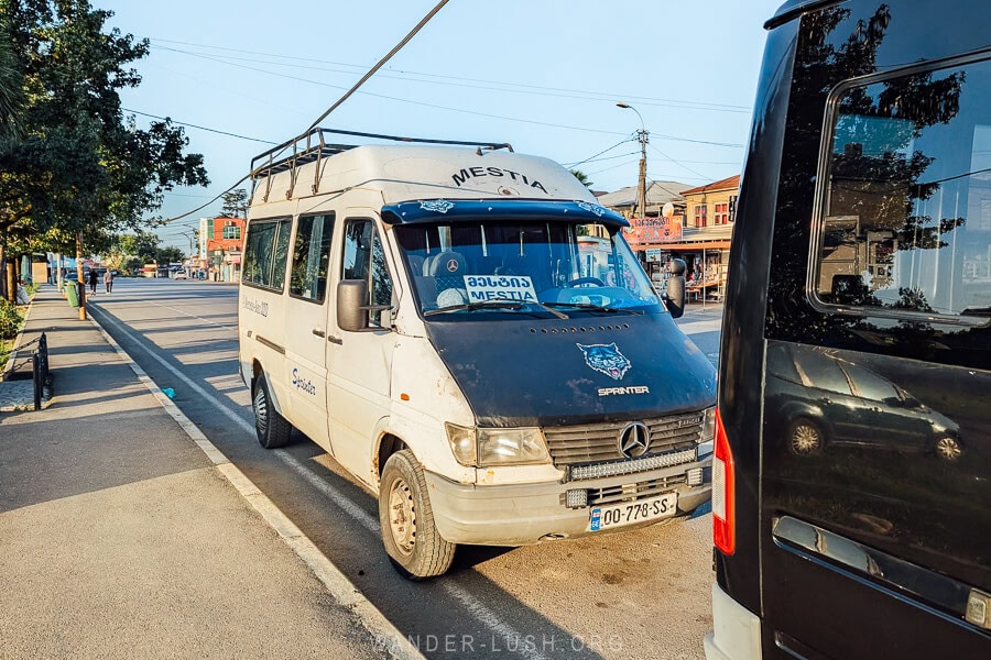 A minivan with Mestia written on a sign on its windshield waits to collect passengers travelling to Svaneti from Zugdidi.