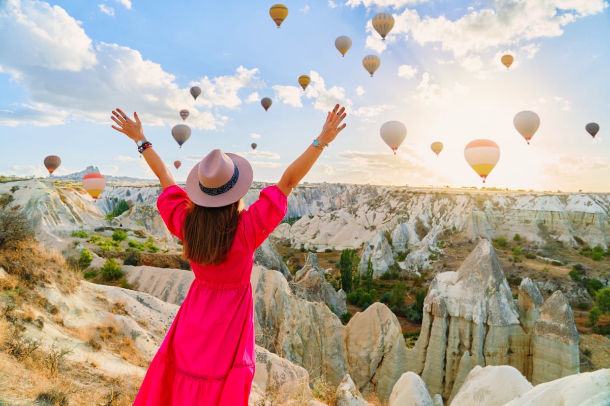 Woman watching the hot air balloons in Cappadocia, Turkey