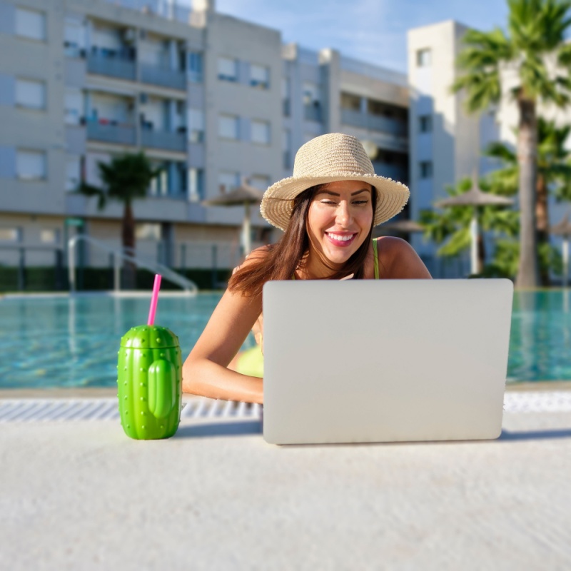 Digital nomad in swimming pool with laptop