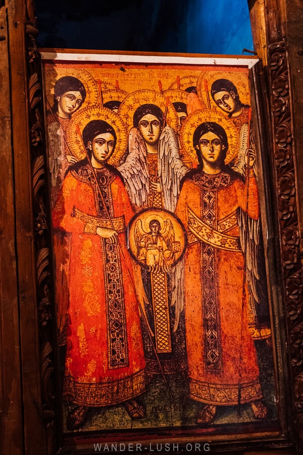 An icon painting in Leus, Albania depicting angles in orange and rust tones.