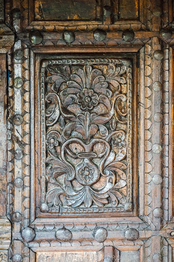 A wooden door carved with floral motifs at the village Leus church near Permet.