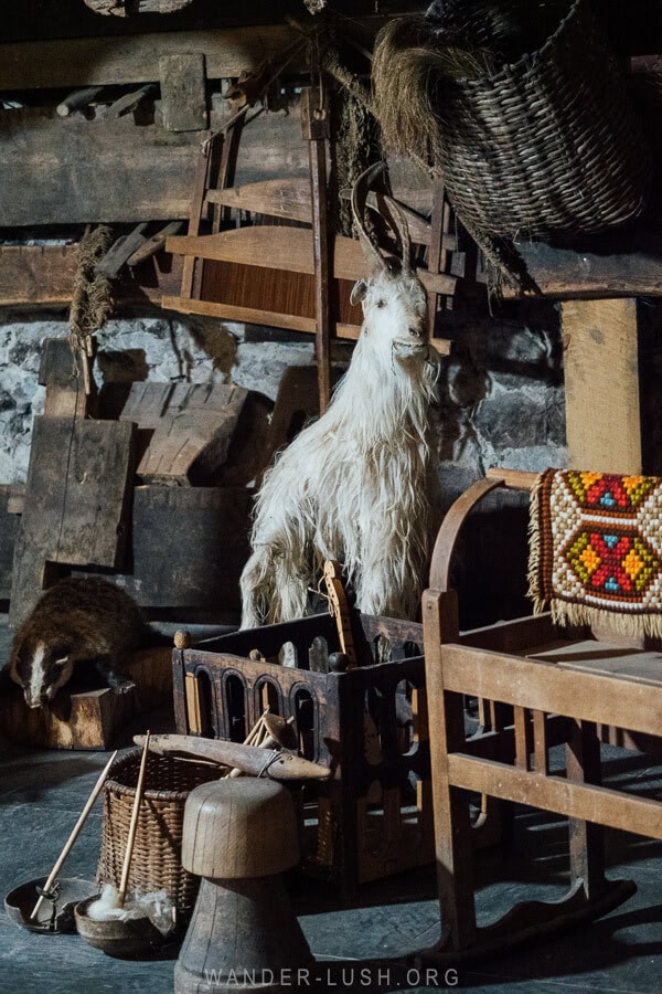 A display of wood carvings and ethnographic objects inside a small house museum in Mestia.