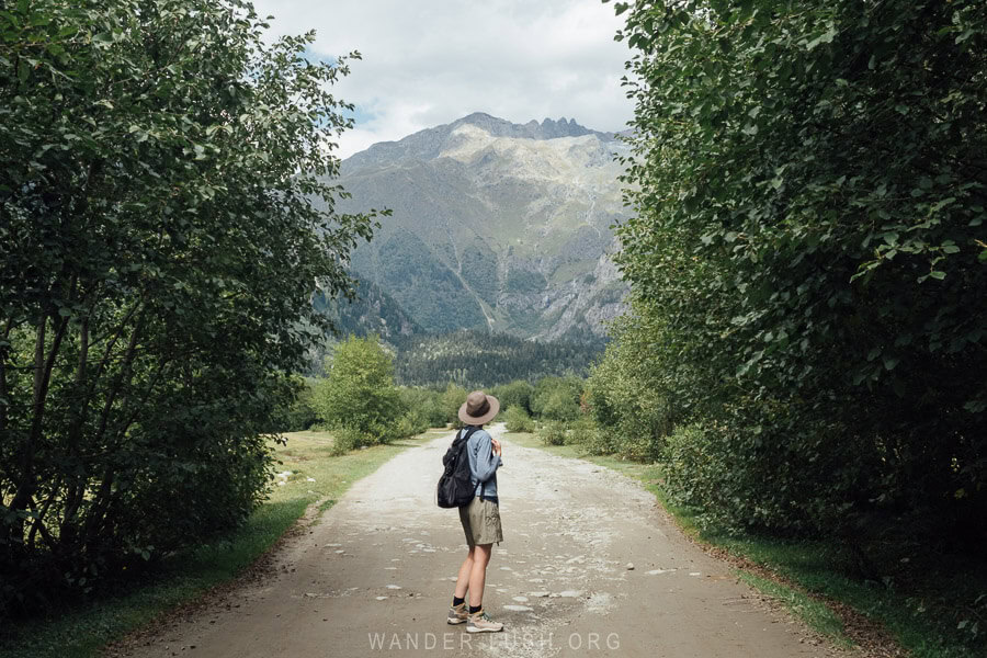 A woman in hiking gear on a trail in Mazeri, Georgia.