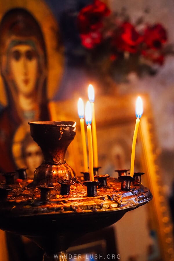 Votive candles and an icon of the Virgin Mary inside Ushguli Lamaria Church.