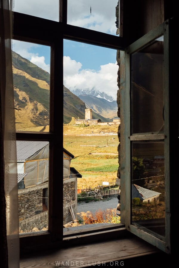 View of Ushguli church from a wooden window at a guesthouse.