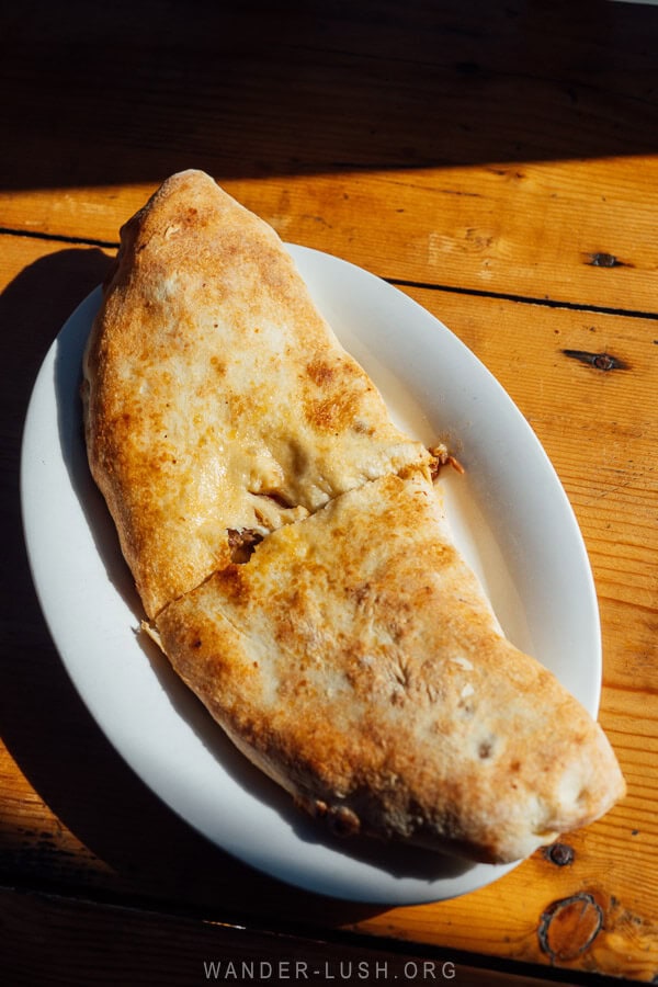 A Svanetian kubdari meat pie on a plate at a small bakery in Lentekhi.