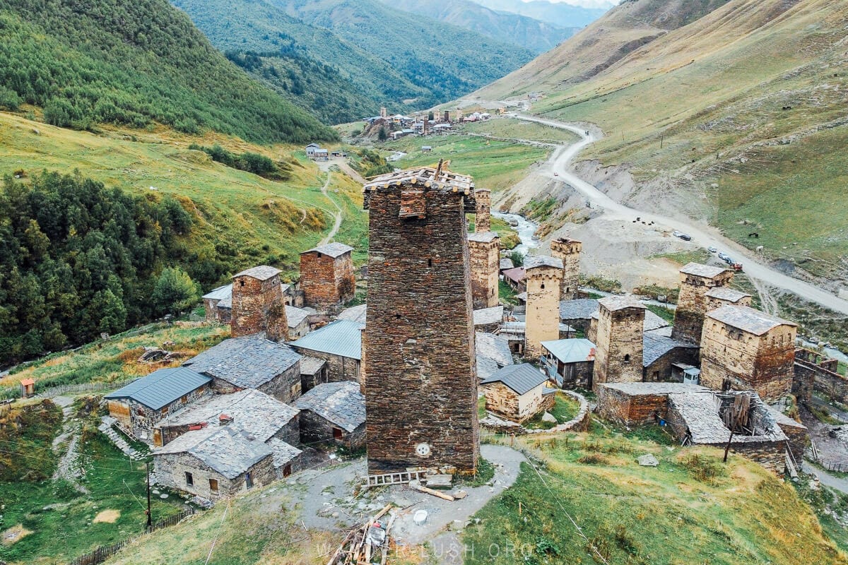 A landscape of river valleys and mountains with stone houses and defensive towers in Ushguli, Georgia.