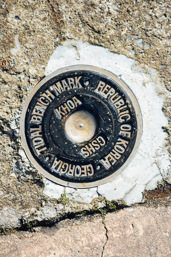 A metal plate on the boardwalk in Anaklia, Georgia marks the tidal benchmark.