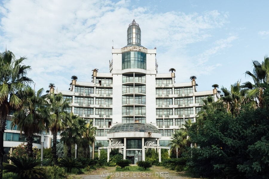 The abandoned Golden Fleece Hotel in Anaklia, a grand resort with overgrown gardens.