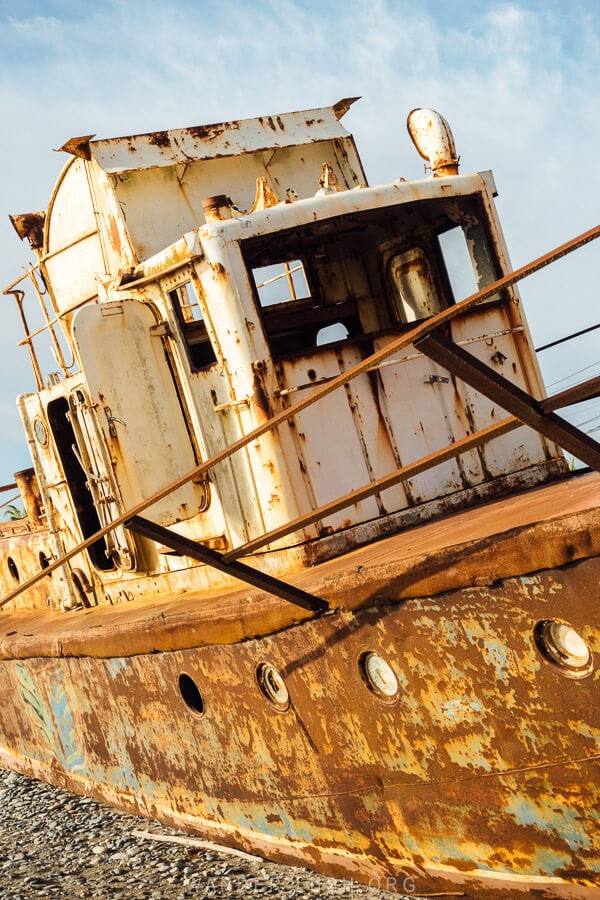 The Morskoy Konik shipwreck, a small rusted out ship on the sand in Anaklia, Georgia.