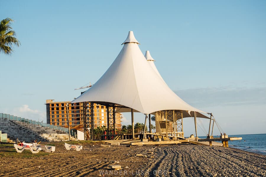 Two white tents form a roof over the abandoned Ganmukhuri Amphitheatre on the Black Sea in Anaklia, Georgia.