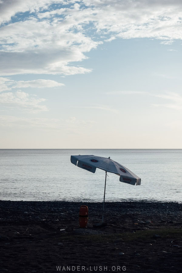 An umbrella pitched in the pebbles on Anaklia Beach.