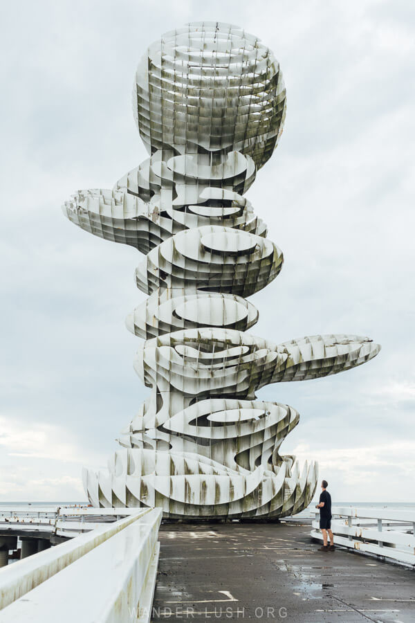 A man stands at the base of the Pier Sculpture, a 33-metre-high artwork on the Black Sea Coast of Georgia.