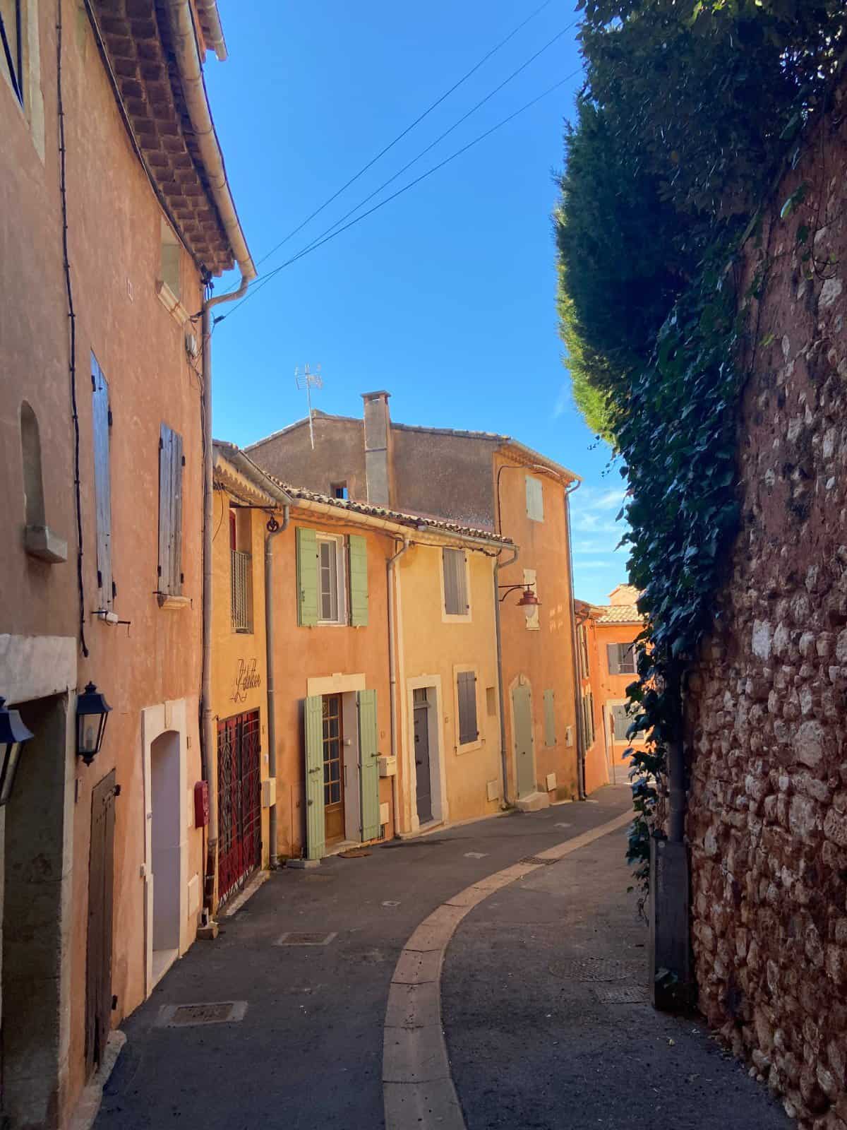 Ochre coloured buildings in Roussillon, a great day trip from Avignon