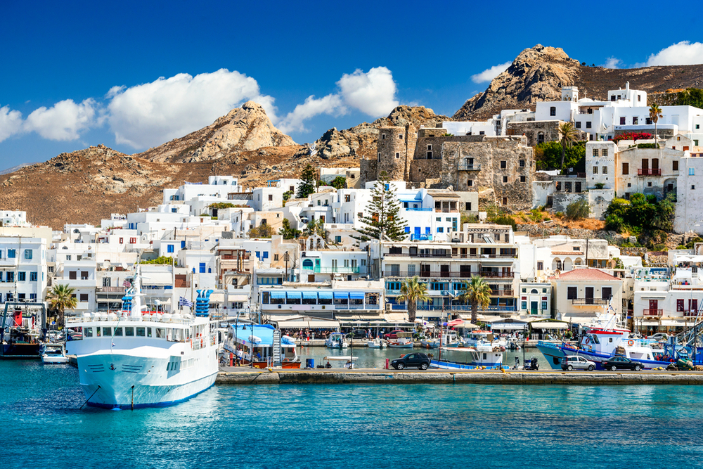 Sunny summer landscape with rocky island, Cyclades in Greece.